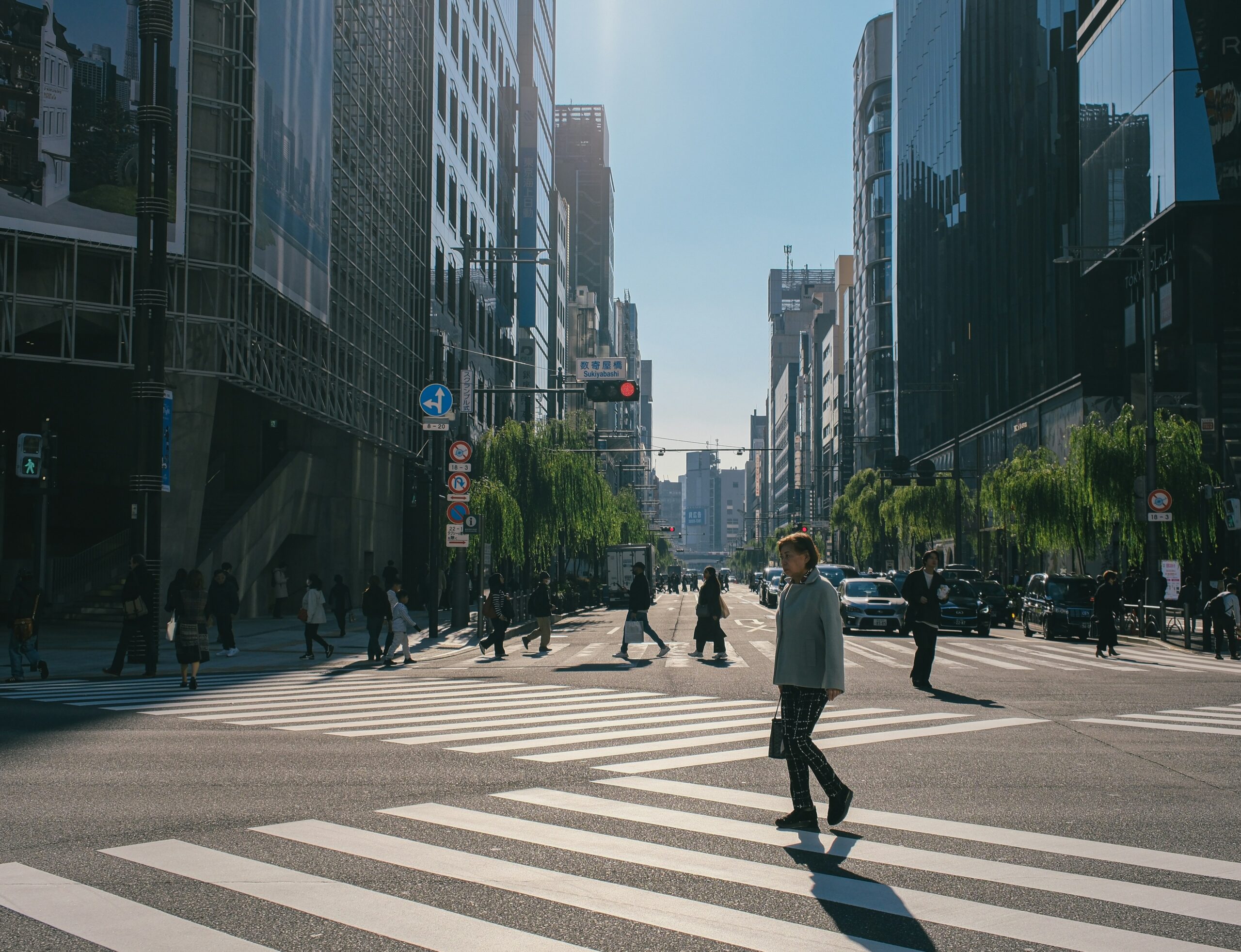Pedestrians crossing a busy city street at a crosswalk