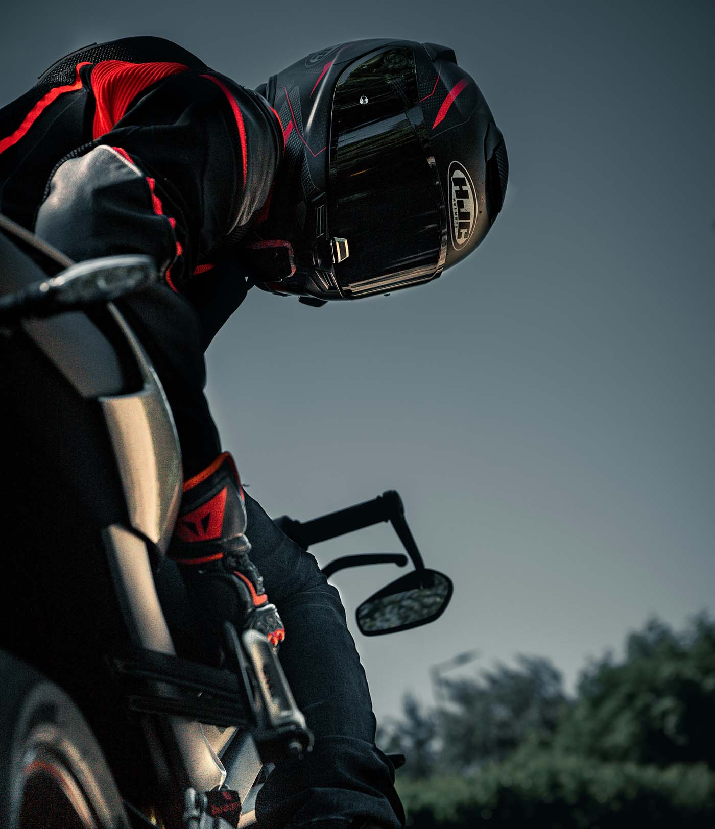 Motorcycle rider wearing protective gear on the road