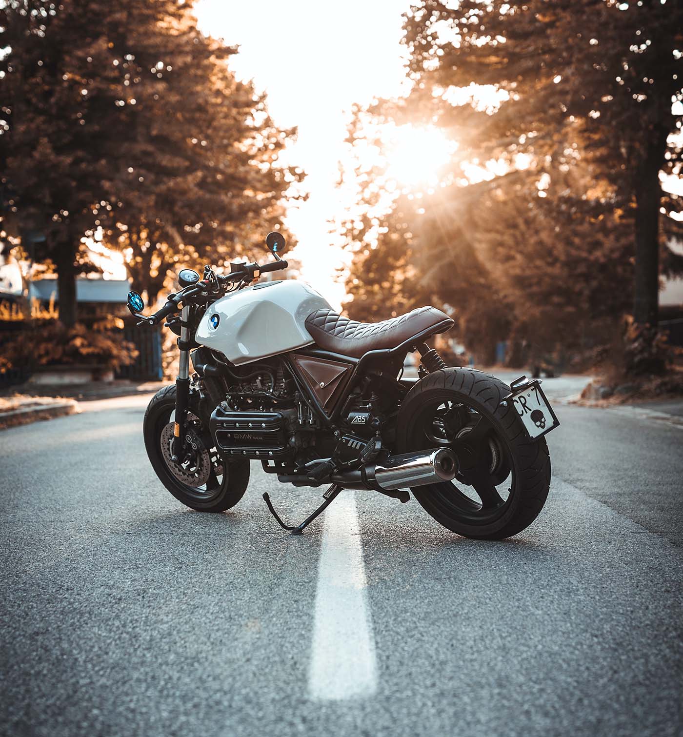 Motorcycle stopped on a roadway at sunset