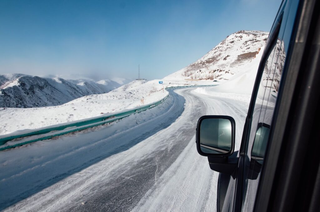 Driver’s view of an icy mountain road in Alaska during winter near Anchorage