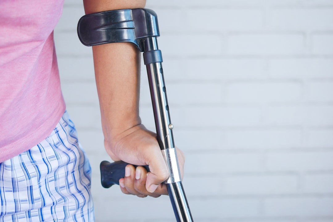 Person using a crutch after a bicycle accident injury