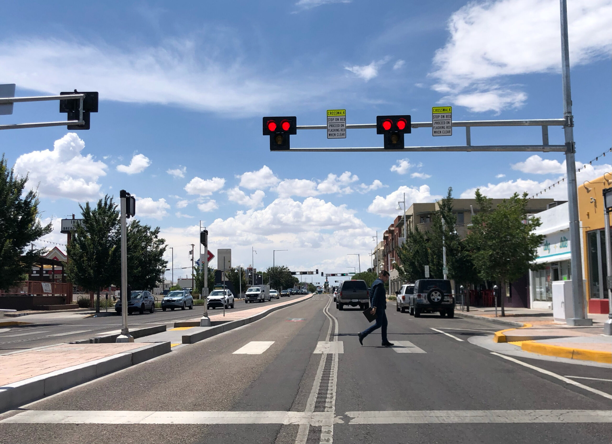 Pedestrian crossing a marked crosswalk on an Albuquerque city street