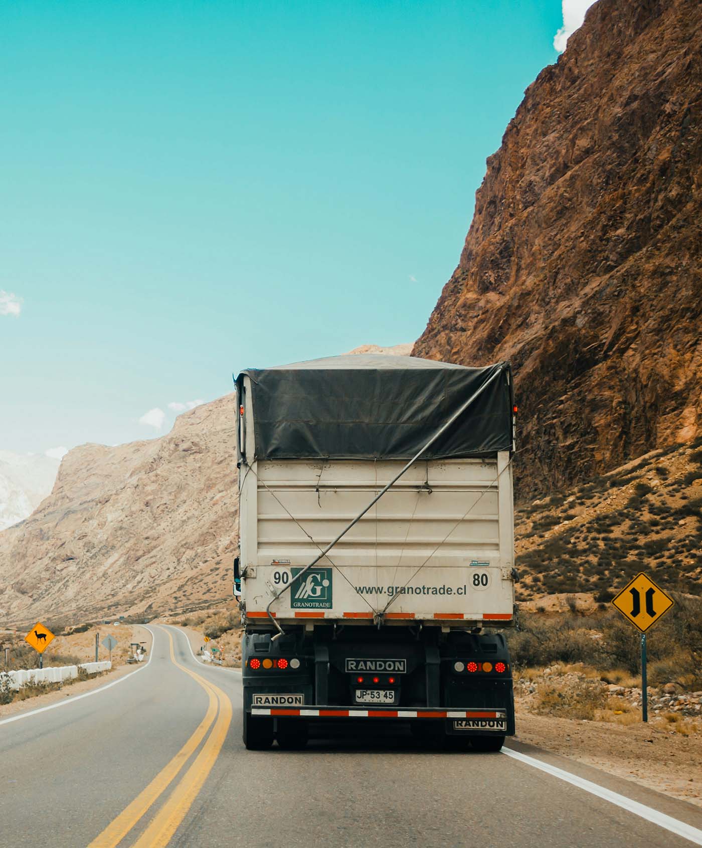 Cargo truck traveling through mountainous terrain
