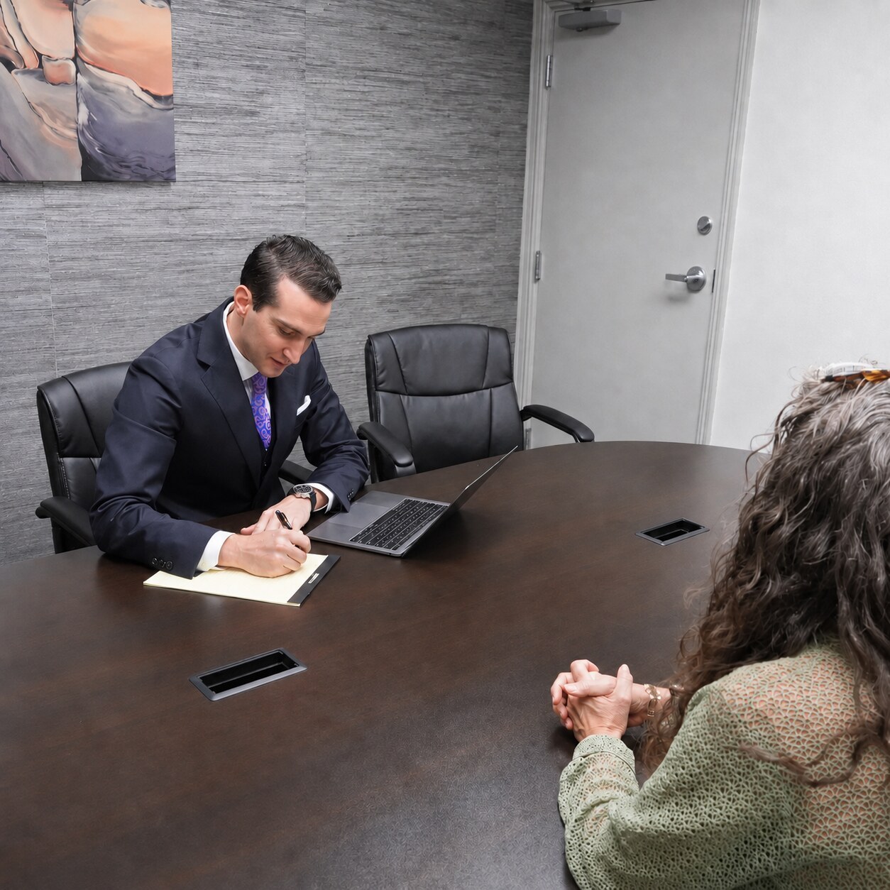 Jed Strong meeting with clients at a conference table